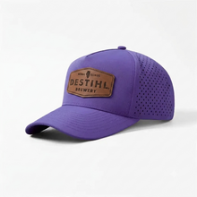 Purple baseball cap with a brown leather patch on a white background