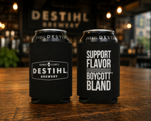 Two black can coolers with DESTIHL Brewery branding on a wooden table.