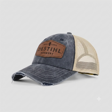 Trucker hat with DESTIHL Brewery logo on it